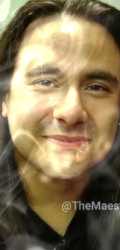 Long-haired man smiling with soft lighting.