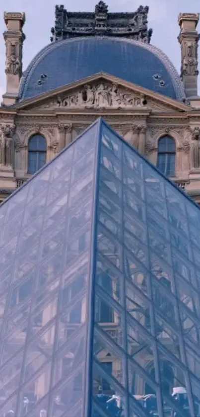 Louvre Pyramid and historic museum facade in Paris.