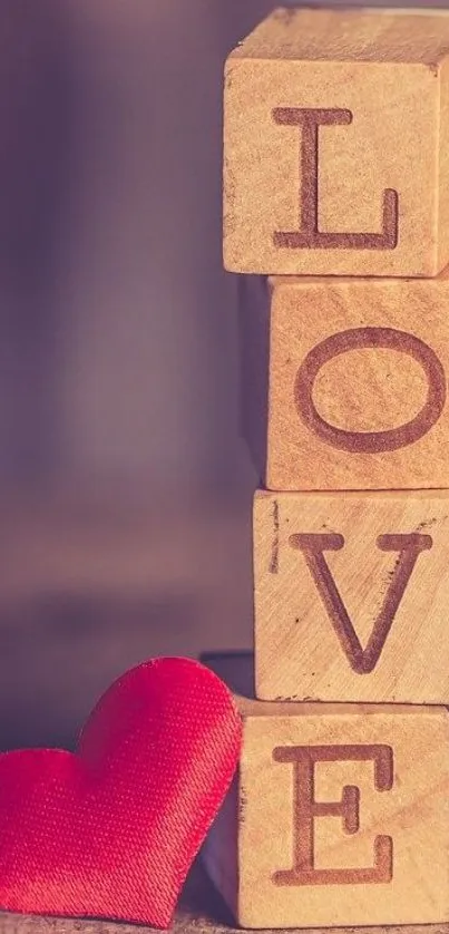 Wooden blocks spelling LOVE with a red heart on a brown background.