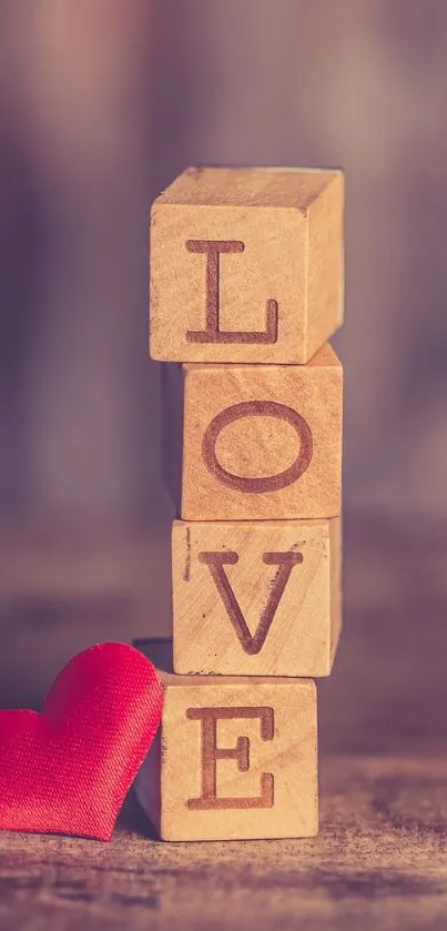 Wooden blocks spelling LOVE with a red heart on a brown background.