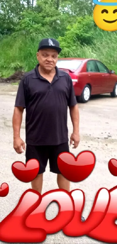 Man standing with love emoji decorations and red cars in background.