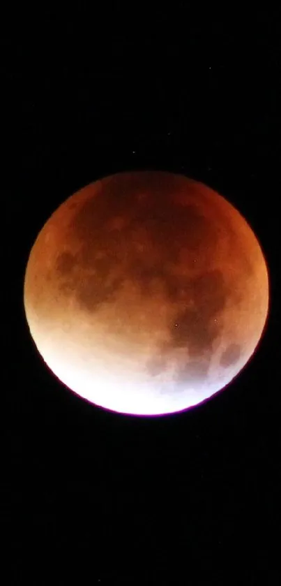 Mobile wallpaper of a lunar eclipse with a glowing, reddish moon in a black sky.