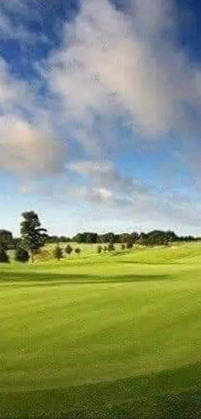 Lush green golf course with blue sky and clouds.