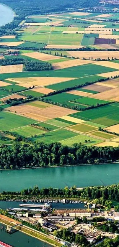 Aerial view of lush green fields and river in the countryside.