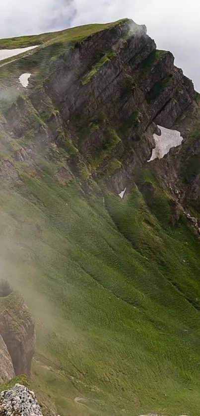 Lush green mountain range with misty slopes.