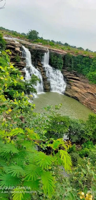 A lush green waterfall scene surrounded by vibrant foliage.