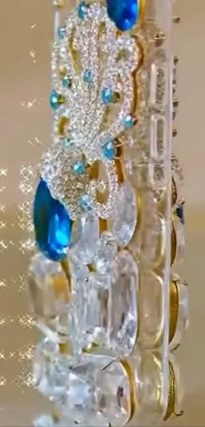 Luxurious phone case with blue gemstones and sparkling design.