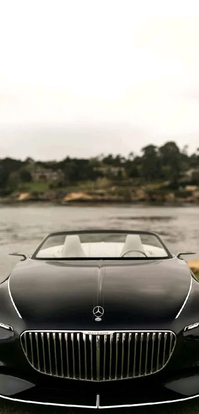 Front view of a luxurious convertible car by the water.