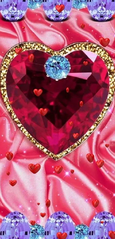 Heart-shaped red gem with blue and purple stones on silky pink background.