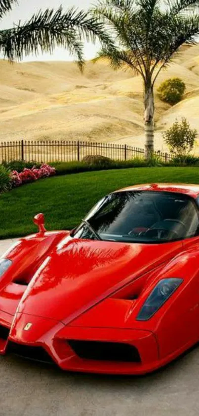 Red sports car on driveway with scenic background.