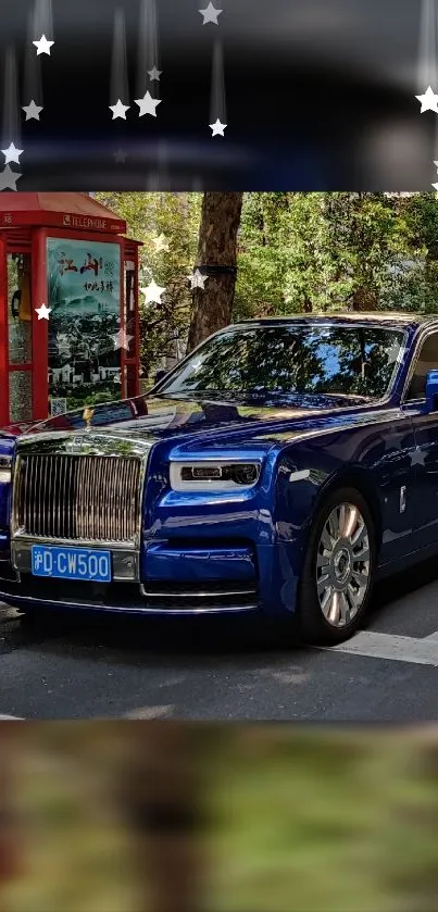 Blue luxury car next to red phone booth with starry sky.