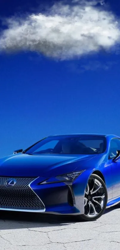 Sleek blue sports car under a vibrant blue sky with clouds.