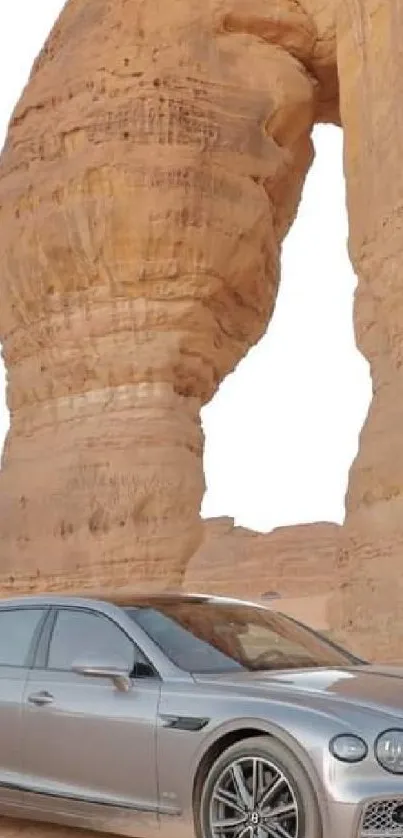 Luxury car parked in front of stunning desert rock formations.