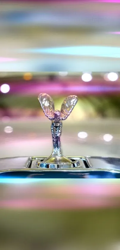 Luxury car hood ornament with pink tones and elegant design.