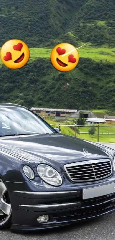 Luxury car in front of lush green mountains on a clear day.