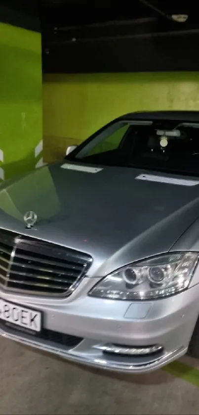 Luxury sedan parked in a green-walled urban garage.