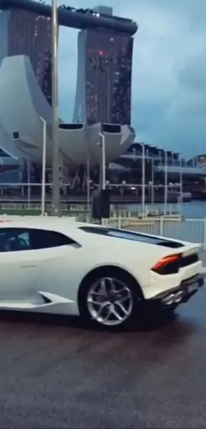 White luxury sports car with city backdrop.