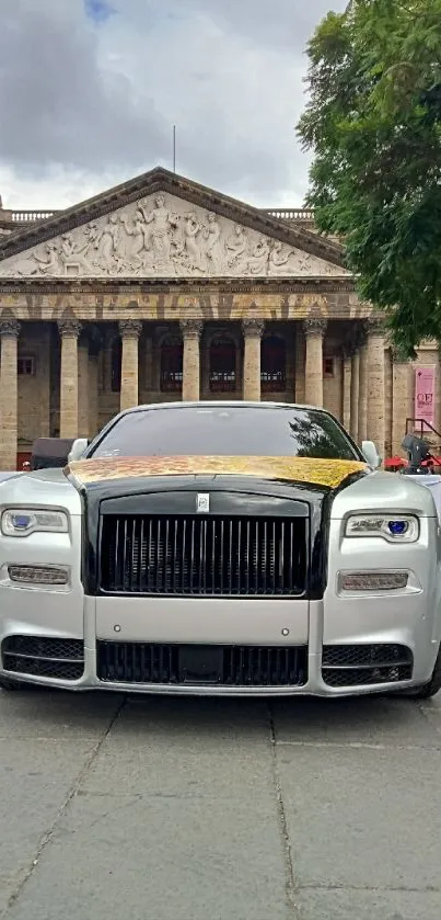 Luxury car front view with historic building backdrop.