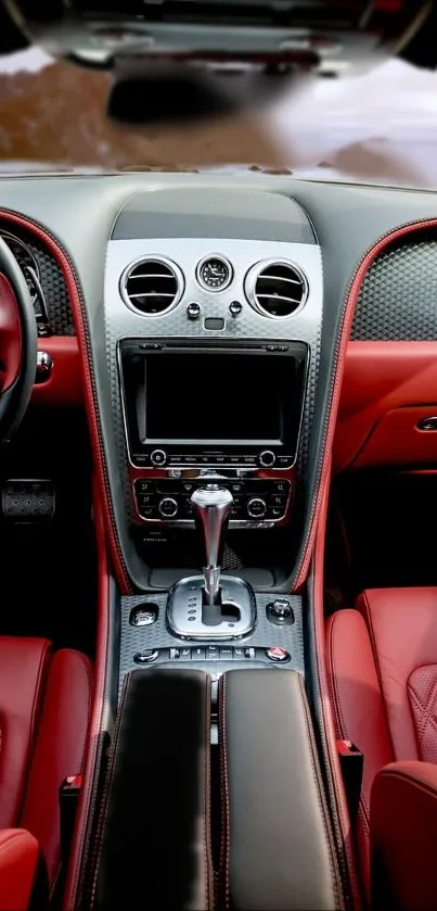 Luxury car interior with red leather seats and sleek dashboard.
