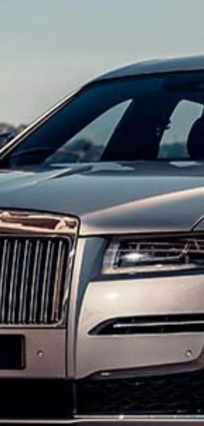 Luxury silver car with a sleek design on a sunny day.