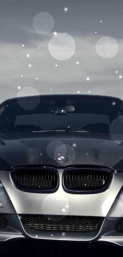 Luxury car against night sky with bokeh lights.