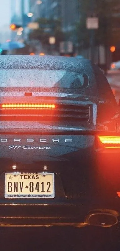 Rear view of a luxury sports car on a rainy city street.