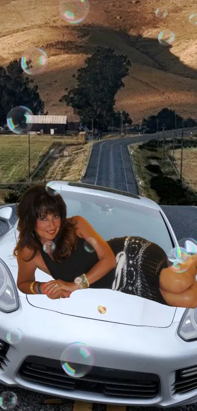 Luxury car with scenic countryside and bubbles on road.