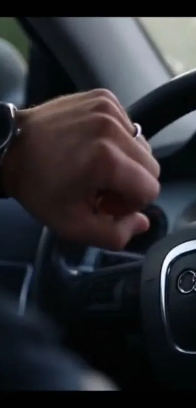 Hand on steering wheel with wristwatch in luxury car.