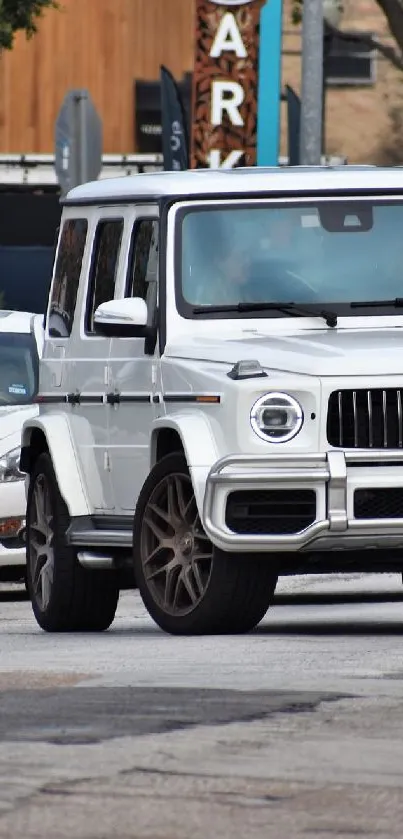 Luxury SUV cruising through city traffic on a bustling street.