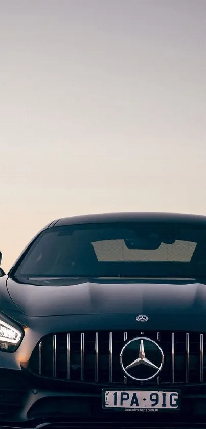 Luxury car silhouette at sunset in scenic background.