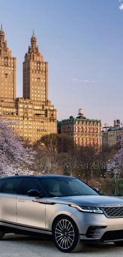 Luxury car in cityscape with cherry blossoms, sunset view.