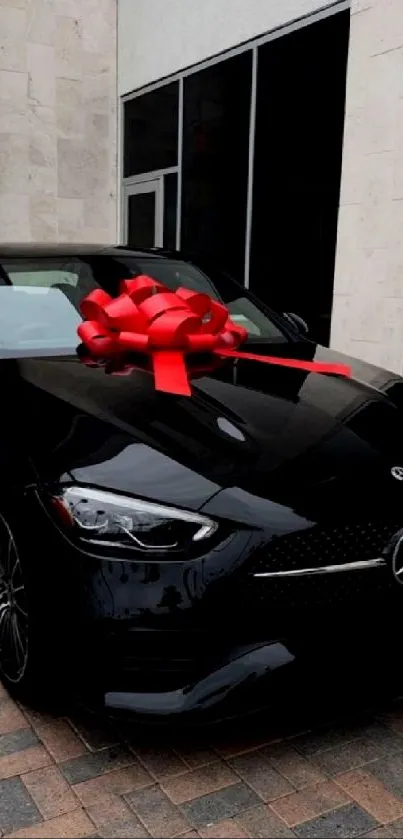 Luxury black car with a red bow on the hood, suitable for phones.