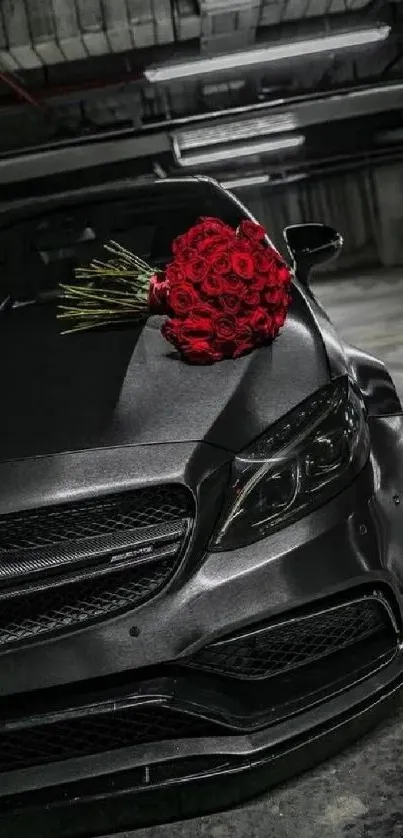 Sleek black luxury car with red roses bouquet on hood.