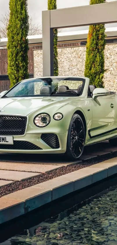 Luxury convertible car parked by a poolside in an elegant setting.