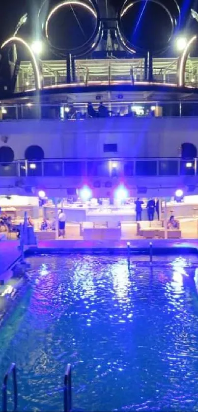 Illuminated luxury cruise ship with pool at night.