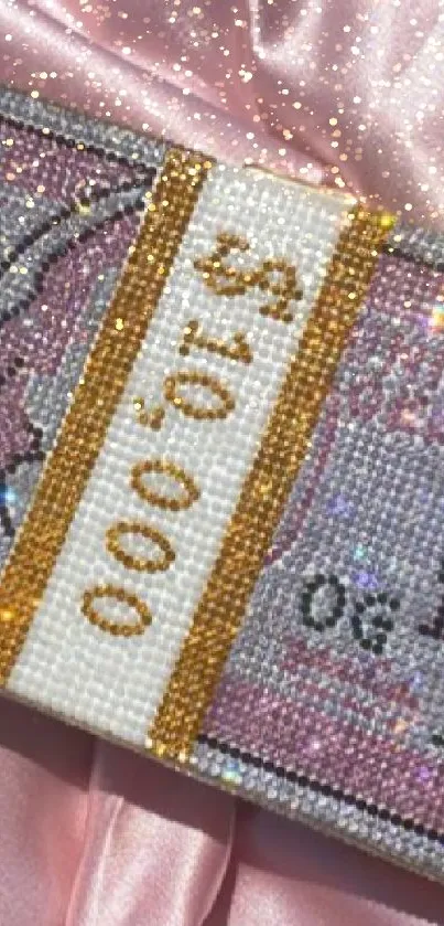 Crystal-encrusted money stack on shiny pink fabric wallpaper.