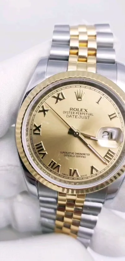 Luxury gold Rolex watch with two-tone bracelet.