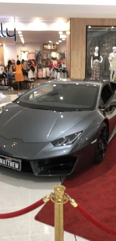 Grey luxury sports car in a stylish showroom setting.