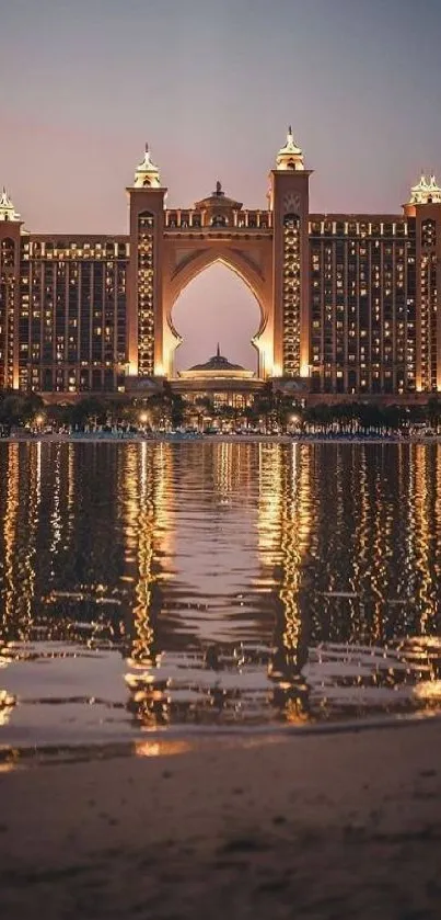 Luxurious hotel at night with reflections on water.