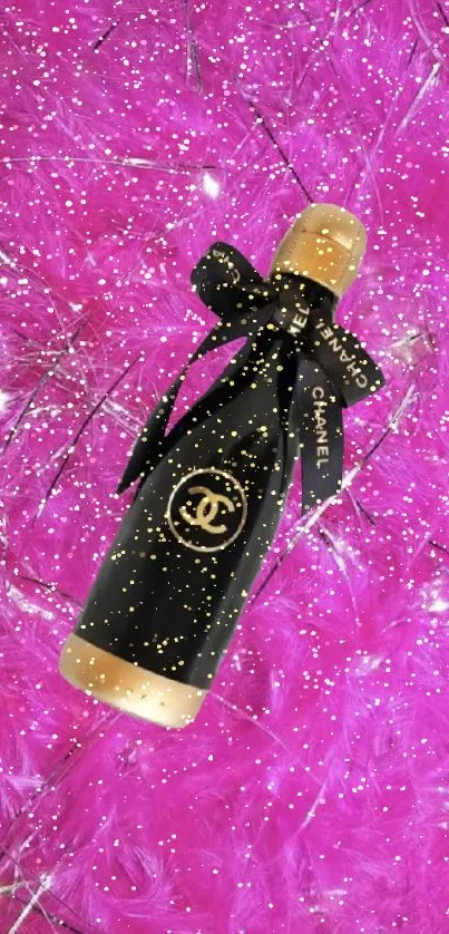 Chanel perfume bottle on pink feather background.