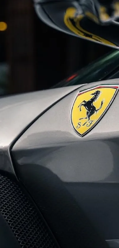 Close-up of a luxury car emblem on a sleek, gray surface.