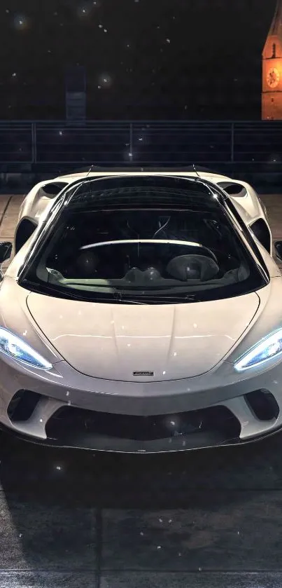 Luxury sports car parked at night with urban background.