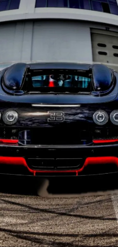 Rear view of a luxury sports car with sleek black design and red accents.