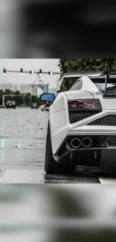 Sleek white sports car parked on a rainy urban street.