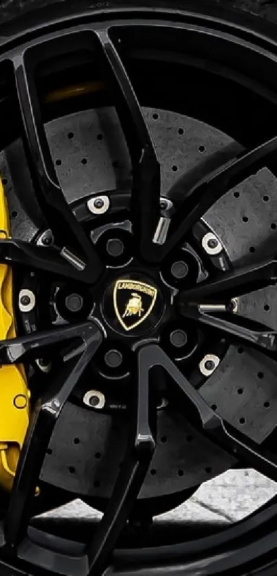 Close-up of luxury car wheel with yellow brake caliper.