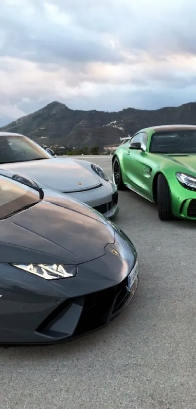 Three luxury sports cars in a mountain view setting.