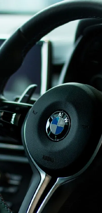 Close-up of a luxury car steering wheel focusing on sleek design.