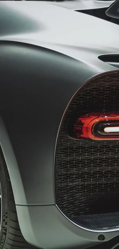 Luxury black supercar on a showroom floor, showcasing sleek rear design.