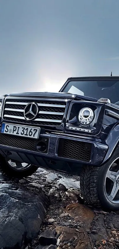 Luxury SUV on rugged rocks under dramatic sky.