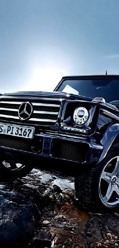 Sleek black SUV on rocky terrain, luxury and power.